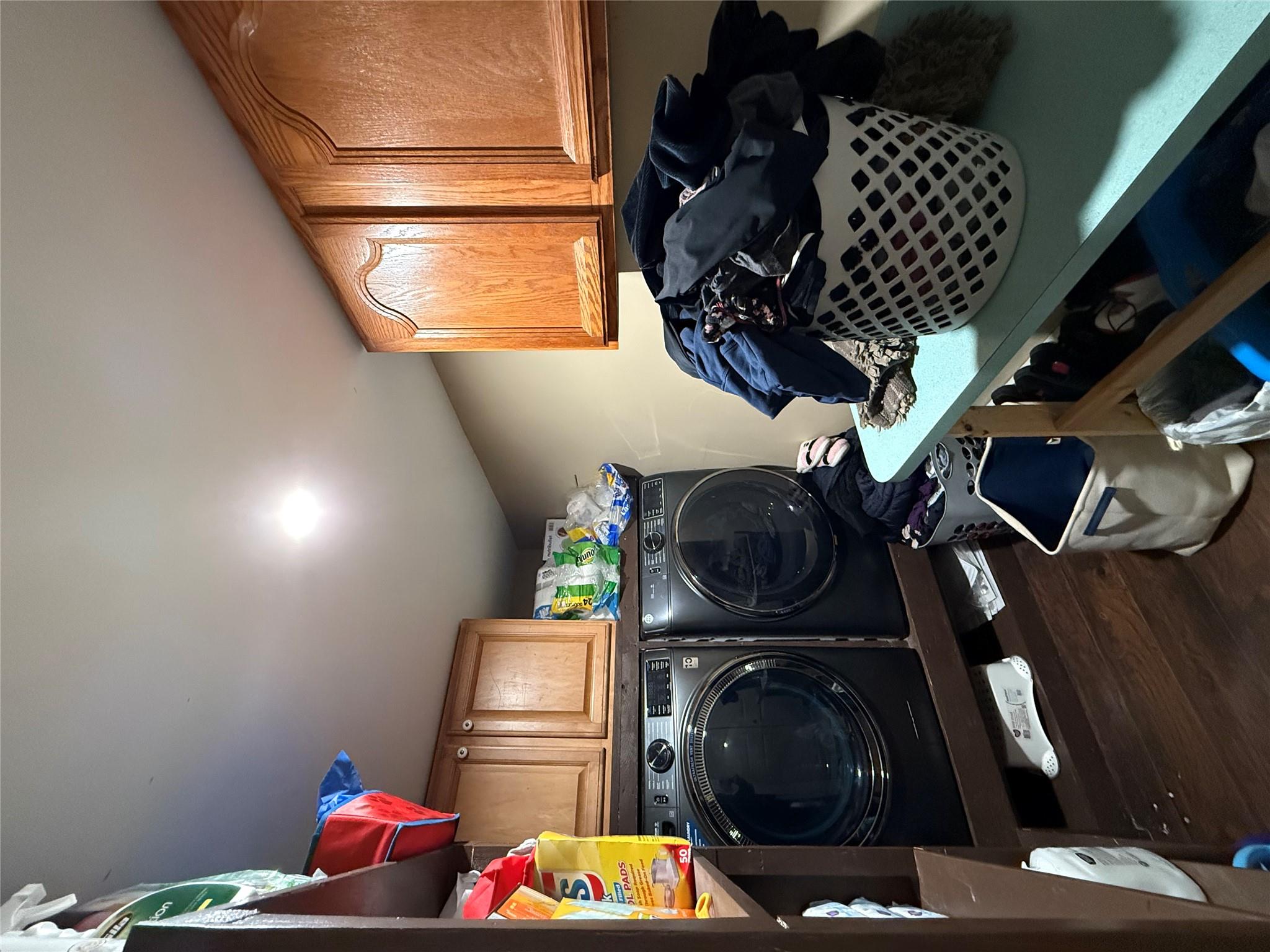 17 Hampton Road Shirley, NY 11967 - Photo 15 of 26 Clothes washing area featuring cabinet space, washer and clothes dryer, and wood finished floors