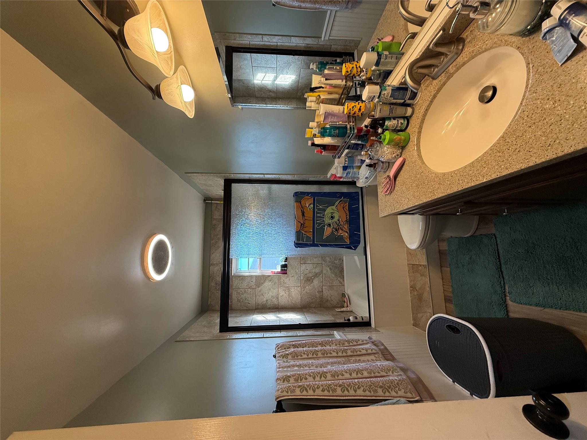 17 Hampton Road Shirley, NY 11967 - Photo 9 of 26 Bathroom with tiled shower / bath combo, vanity, and toilet