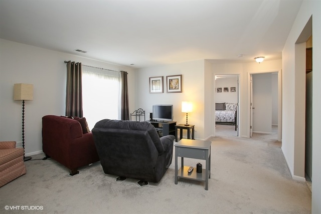 611 West Central Road, Unit C5 Mount Prospect, IL 60056 - Photo 2 of 10 a living room with furniture and a window
