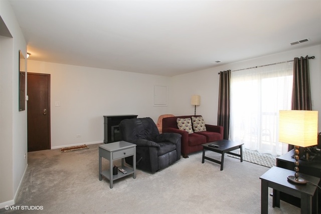 611 West Central Road, Unit C5 Mount Prospect, IL 60056 - Photo 3 of 10 a living room with furniture and a window