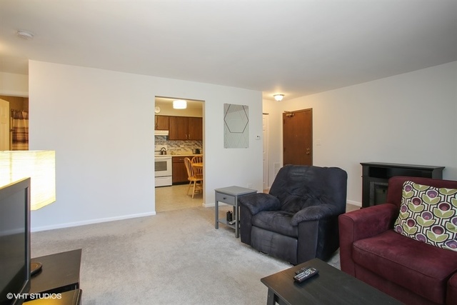 611 West Central Road, Unit C5 Mount Prospect, IL 60056 - Photo 4 of 10 a living room with furniture and a window