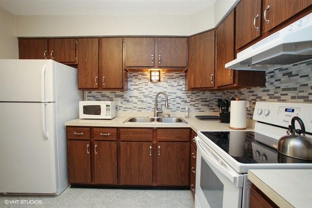 611 West Central Road, Unit C5 Mount Prospect, IL 60056 - Photo 6 of 10 a kitchen with a sink a refrigerator and cabinets