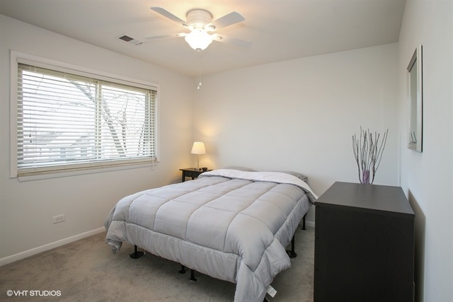 611 West Central Road, Unit C5 Mount Prospect, IL 60056 - Photo 7 of 10 a bedroom with a bed and a window