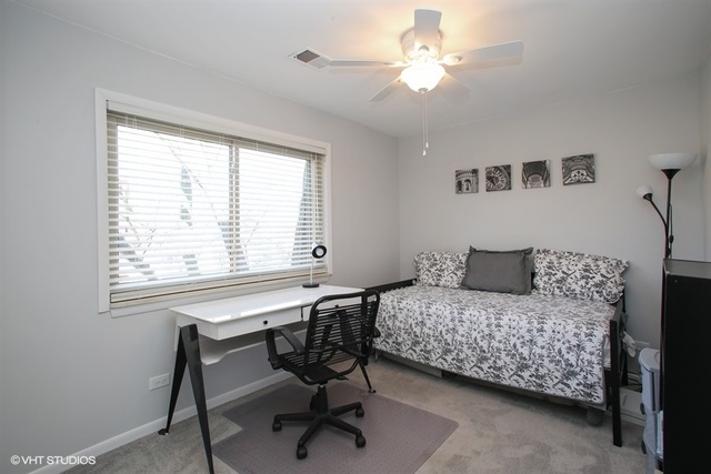 611 West Central Road, Unit C5 Mount Prospect, IL 60056 - Photo 8 of 10 a bedroom with a bed and a window