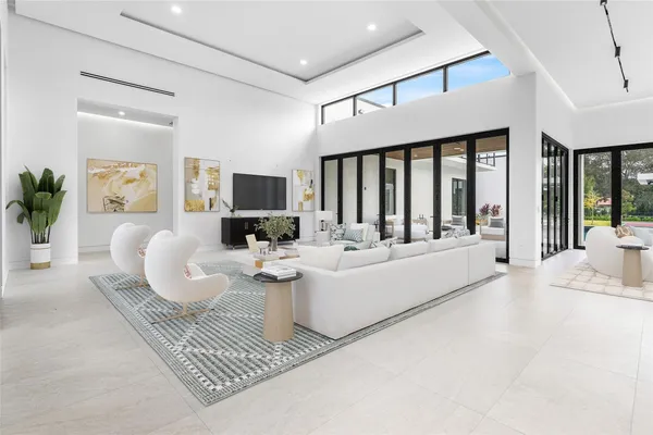 a living room with furniture and view of kitchen