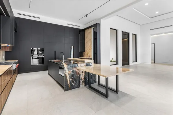 an empty room with sliding glass door and mountain view