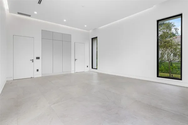 a view of a room with gym equipment and floor to ceiling window