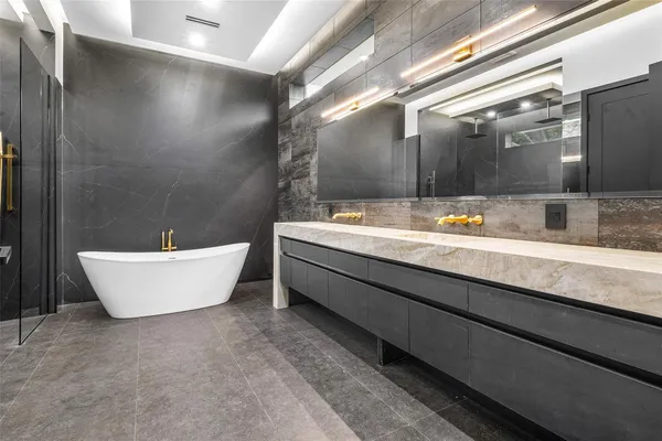 a bathroom with a toilet sink vanity and mirror