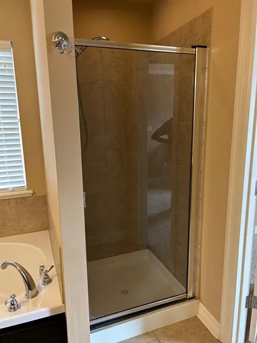 a bathroom with a shower and a sink