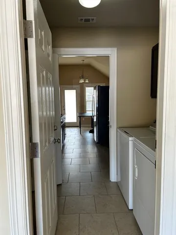 a view of a hallway with wooden shelves