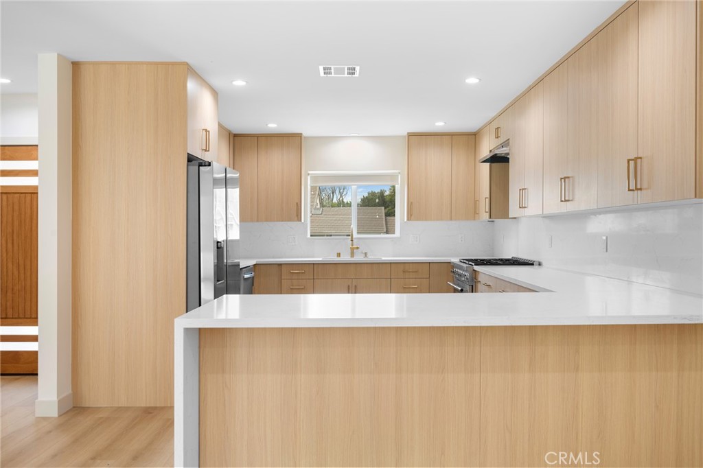 918 University Burbank, CA 91504 - Photo 11 of 30 a large white kitchen with kitchen island a sink stainless steel appliances and cabinets