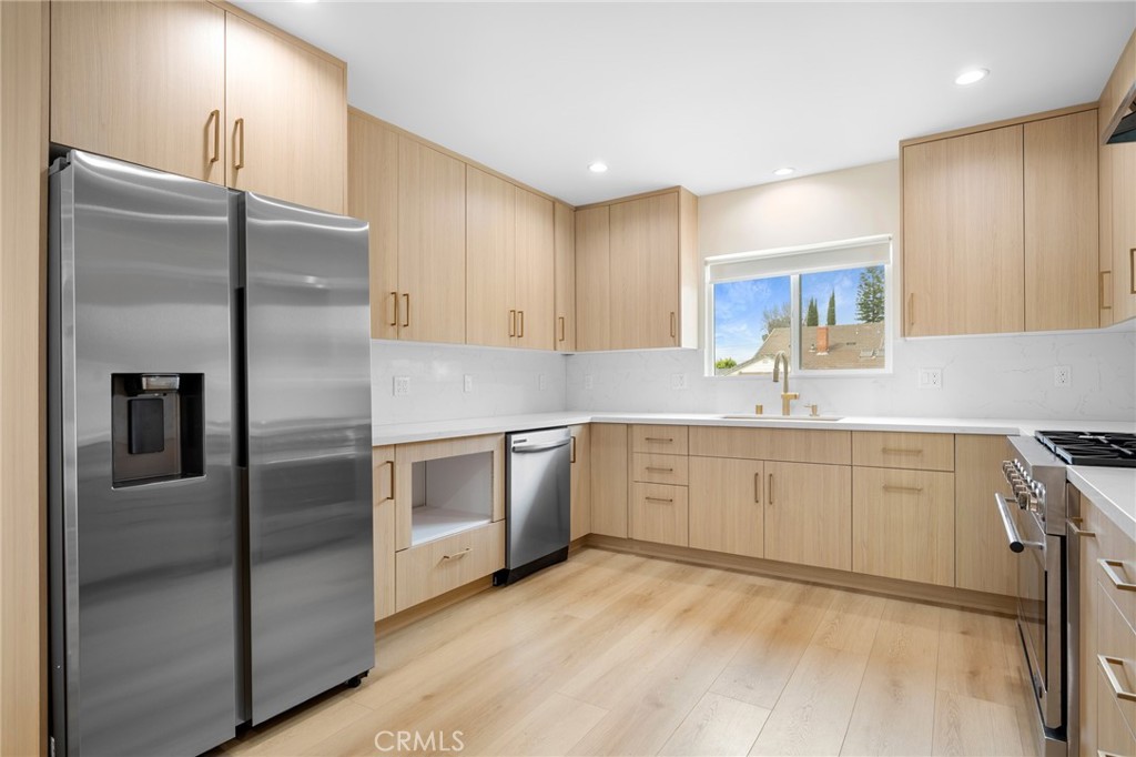 918 University Burbank, CA 91504 - Photo 13 of 30 a kitchen with a refrigerator sink and cabinets