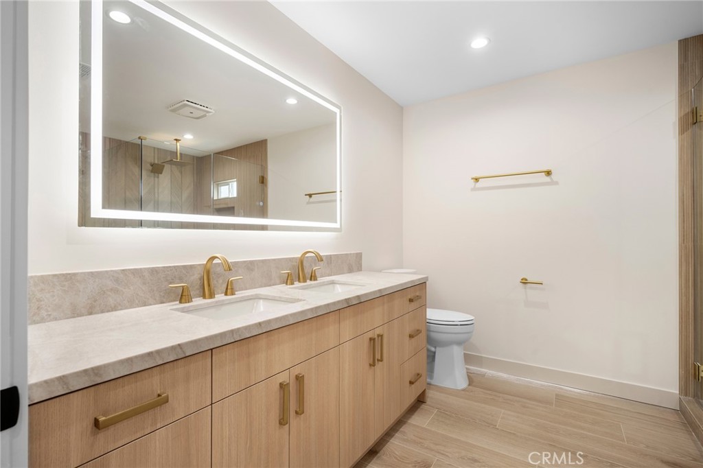 918 University Burbank, CA 91504 - Photo 18 of 30 a bathroom with a toilet sink and mirror