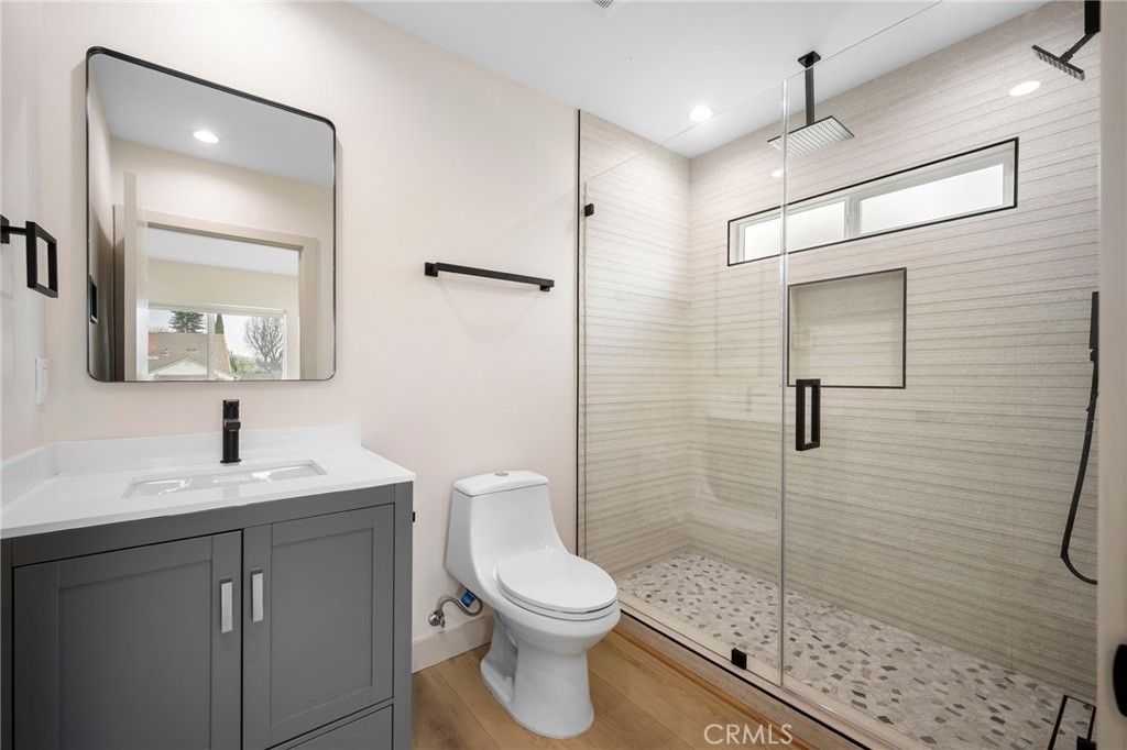 918 University Burbank, CA 91504 - Photo 22 of 30 a bathroom with a toilet a sink a shower and mirror