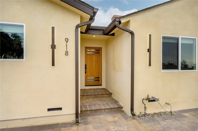 a view of a front door and wooden door