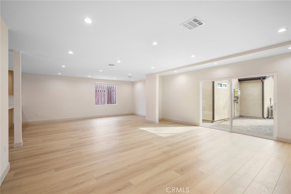 918 University Burbank, CA 91504 - Photo 8 of 30 a view of an empty room with wooden floor and kitchen space