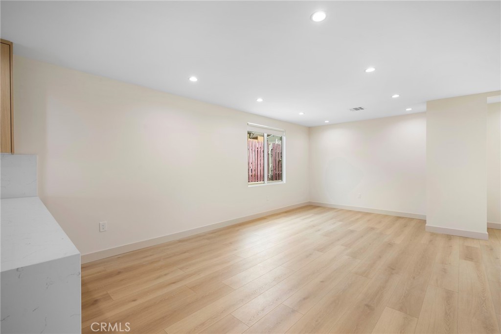 918 University Burbank, CA 91504 - Photo 9 of 30 a view of an empty room with wooden floor and a window