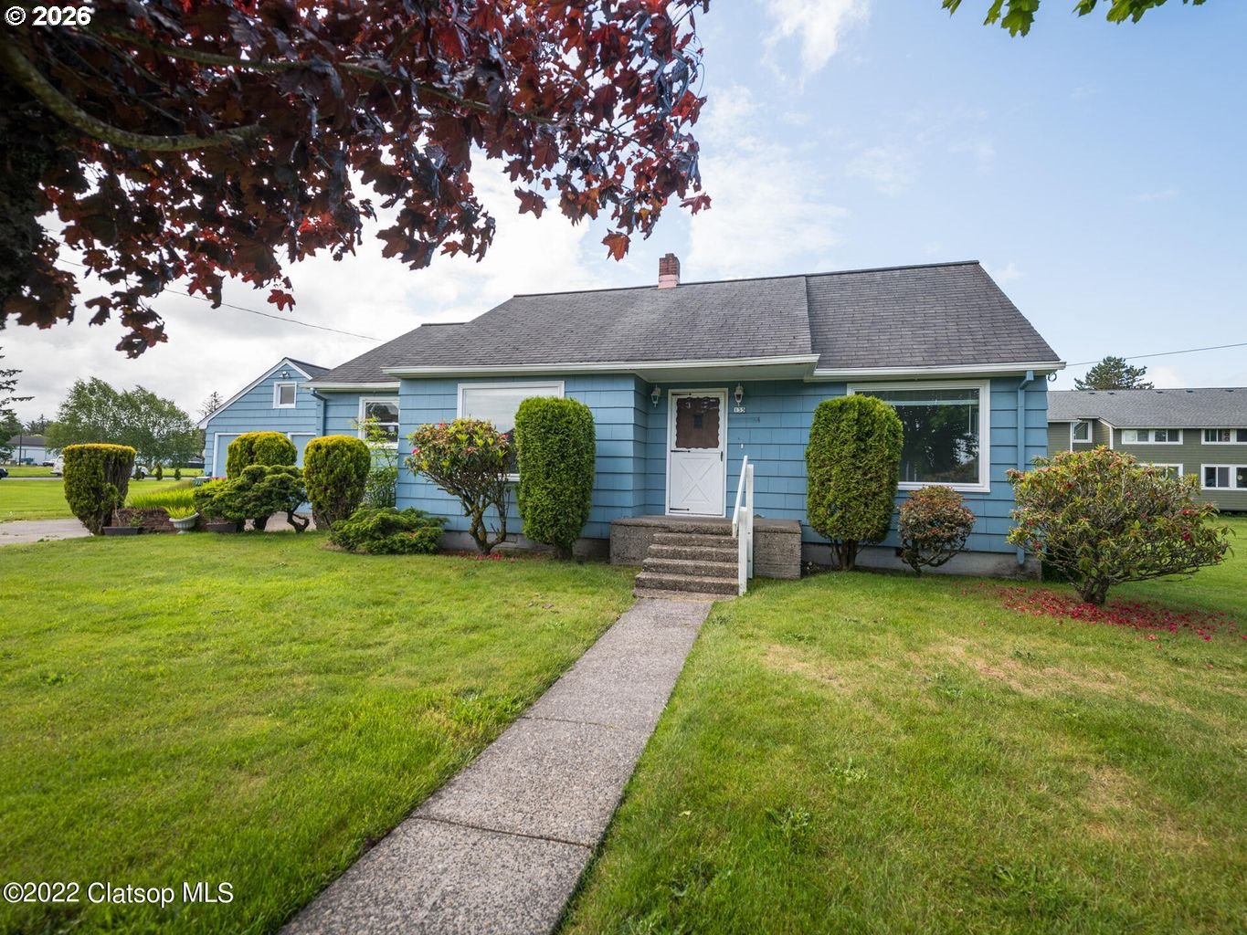 135 Southwest 2nd Street Warrenton, OR 97146 - Photo 12 of 46 a front view of a house with a garden