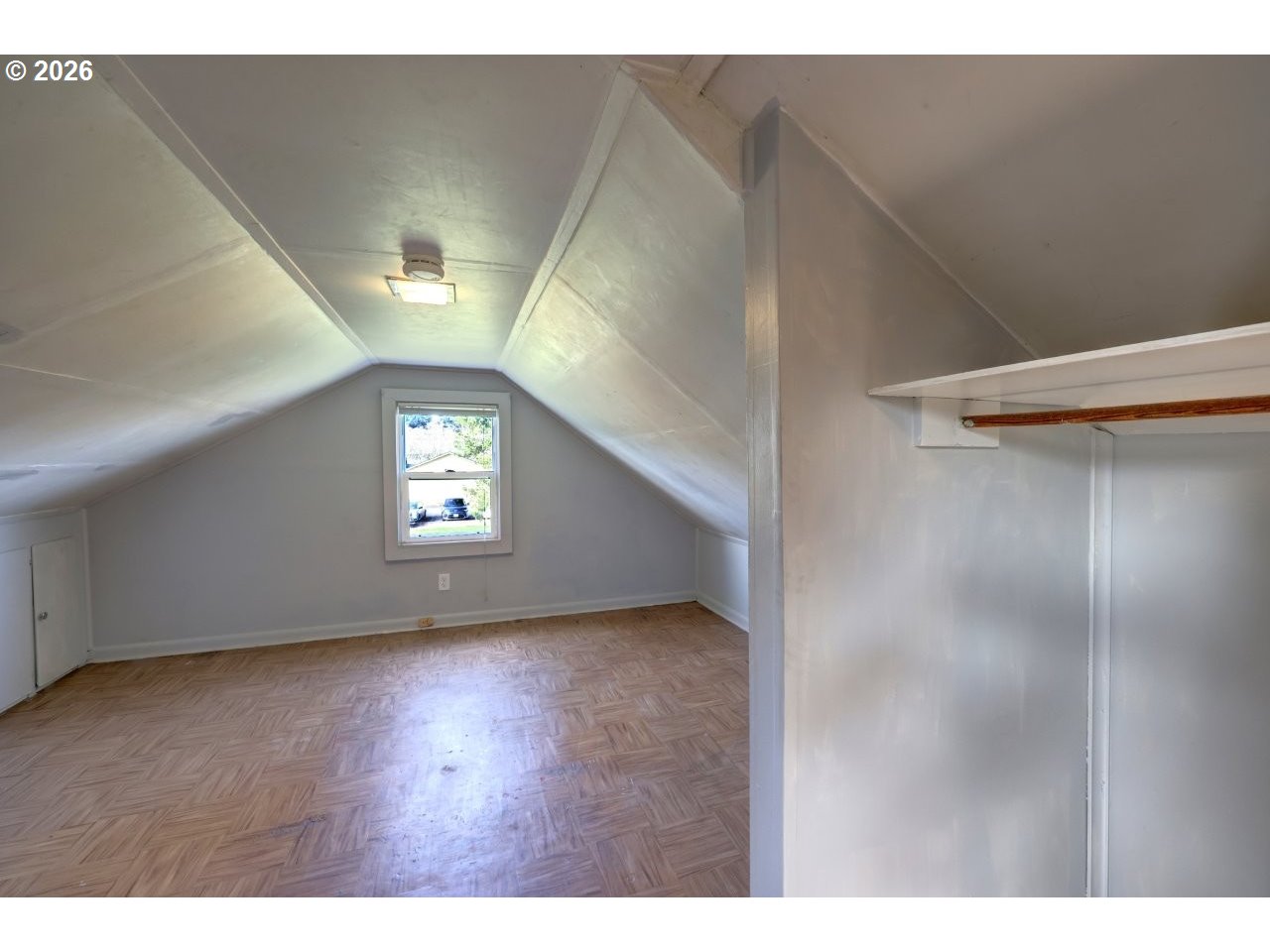 135 Southwest 2nd Street Warrenton, OR 97146 - Photo 33 of 46 a view of an empty room with wooden floor and a window