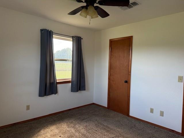 1643 North 4100th Road Soper, OK 74759 - Photo 14 of 30 an empty room with ceiling fan and window