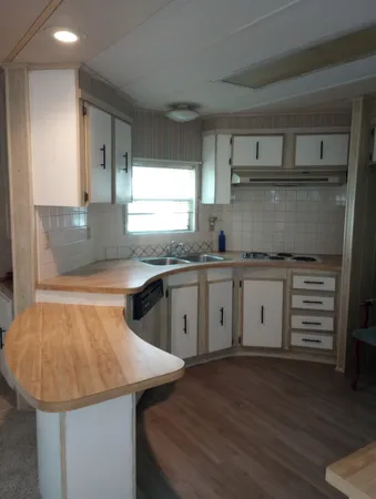 a kitchen with a sink a stove and cabinets