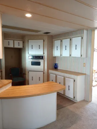 a kitchen with stainless steel appliances kitchen island sink refrigerator and stove