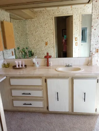 a bathroom with a sink vanity and mirror