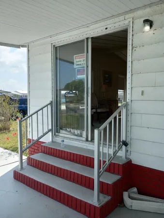 a view of staircase with a rug and a window