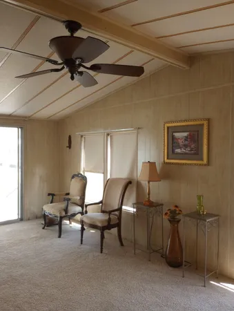 a living room with furniture and a ceiling fan
