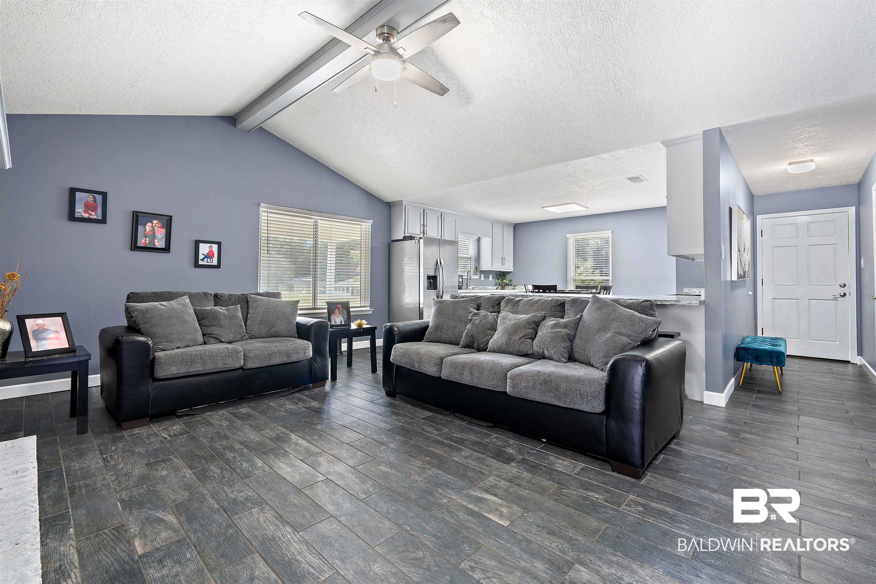 2000 Campfire Drive Semmes, AL 36575 - Photo 6 of 26 Living room with plenty of natural light, lofted ceiling with beams, a textured ceiling, and ceiling fan