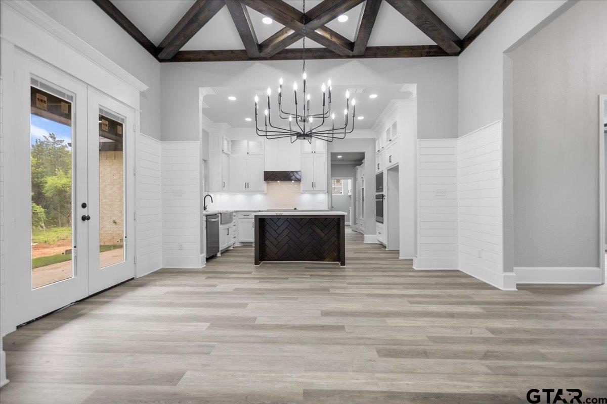 19462 Cedarpark Place Lindale, TX 75771 - Photo 14 of 48 a view of a hallway with wooden floor and chandelier