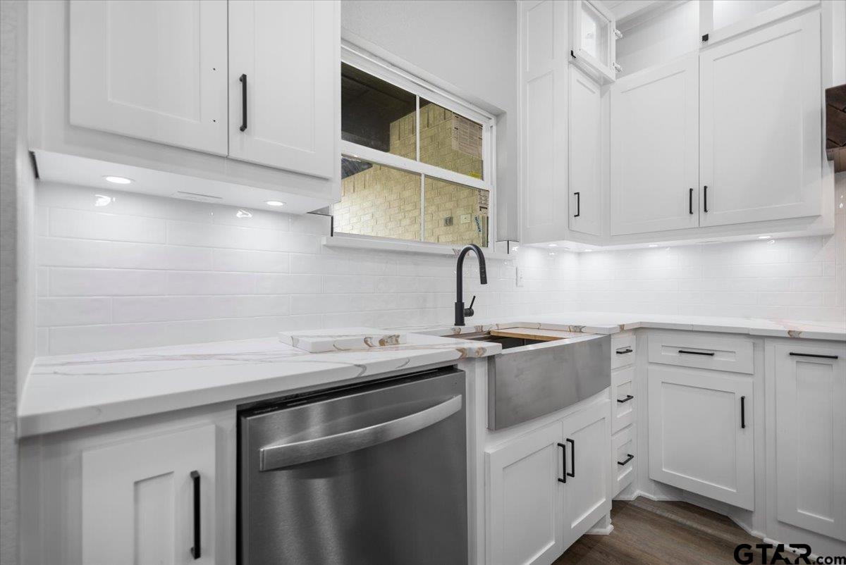 19462 Cedarpark Place Lindale, TX 75771 - Photo 15 of 48 a kitchen with white cabinets sink and stove