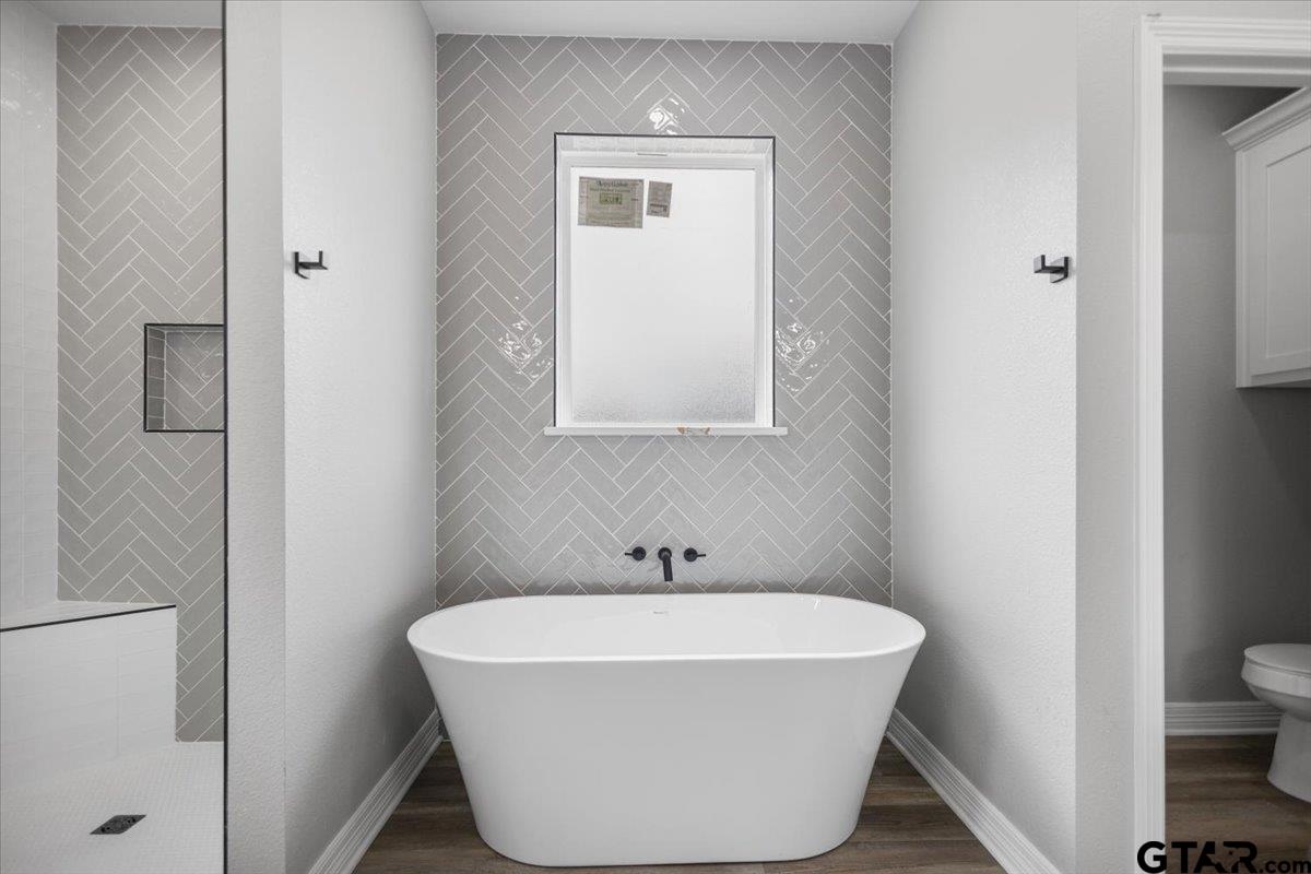19462 Cedarpark Place Lindale, TX 75771 - Photo 24 of 48 a white bath tub sitting next to a white toilet