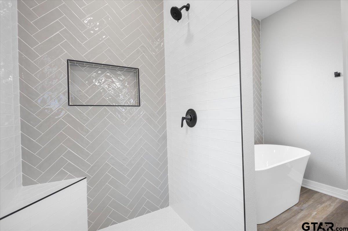 19462 Cedarpark Place Lindale, TX 75771 - Photo 29 of 48 a bathroom with a bathtub and shower
