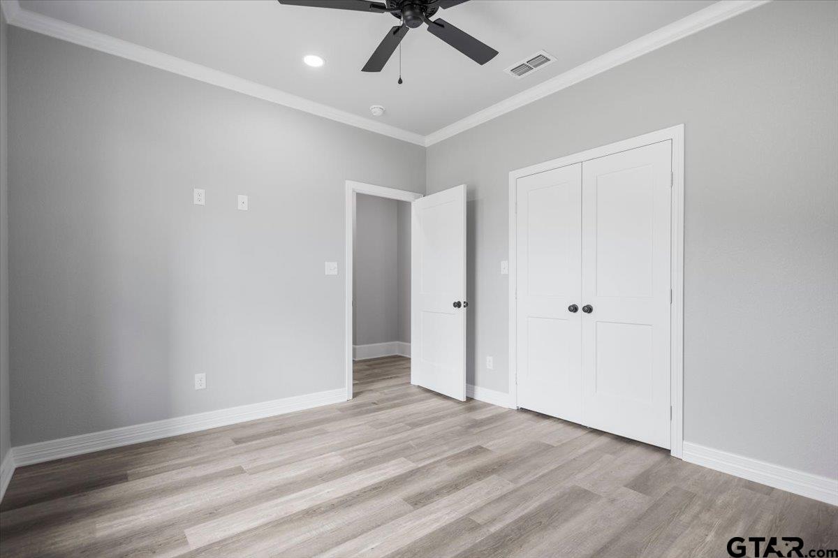 19462 Cedarpark Place Lindale, TX 75771 - Photo 38 of 48 an empty room with wooden floor and ceiling fan