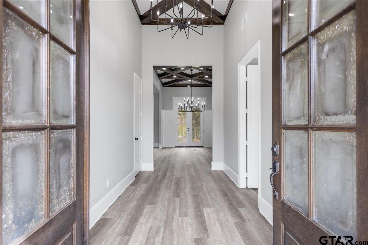 19462 Cedarpark Place Lindale, TX 75771 - Photo 4 of 48 a view of a hallway with wooden floor and staircase