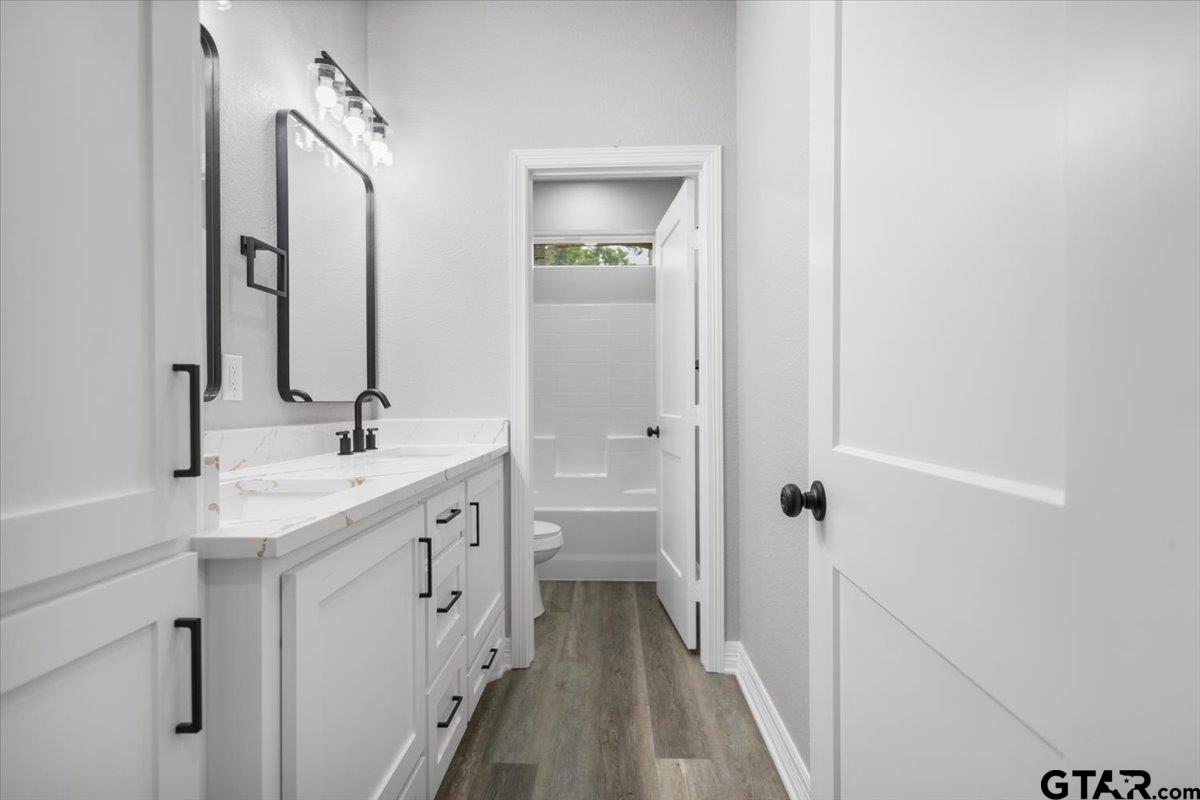 19462 Cedarpark Place Lindale, TX 75771 - Photo 42 of 48 a spacious bathroom with a double vanity sink a mirror and a shower