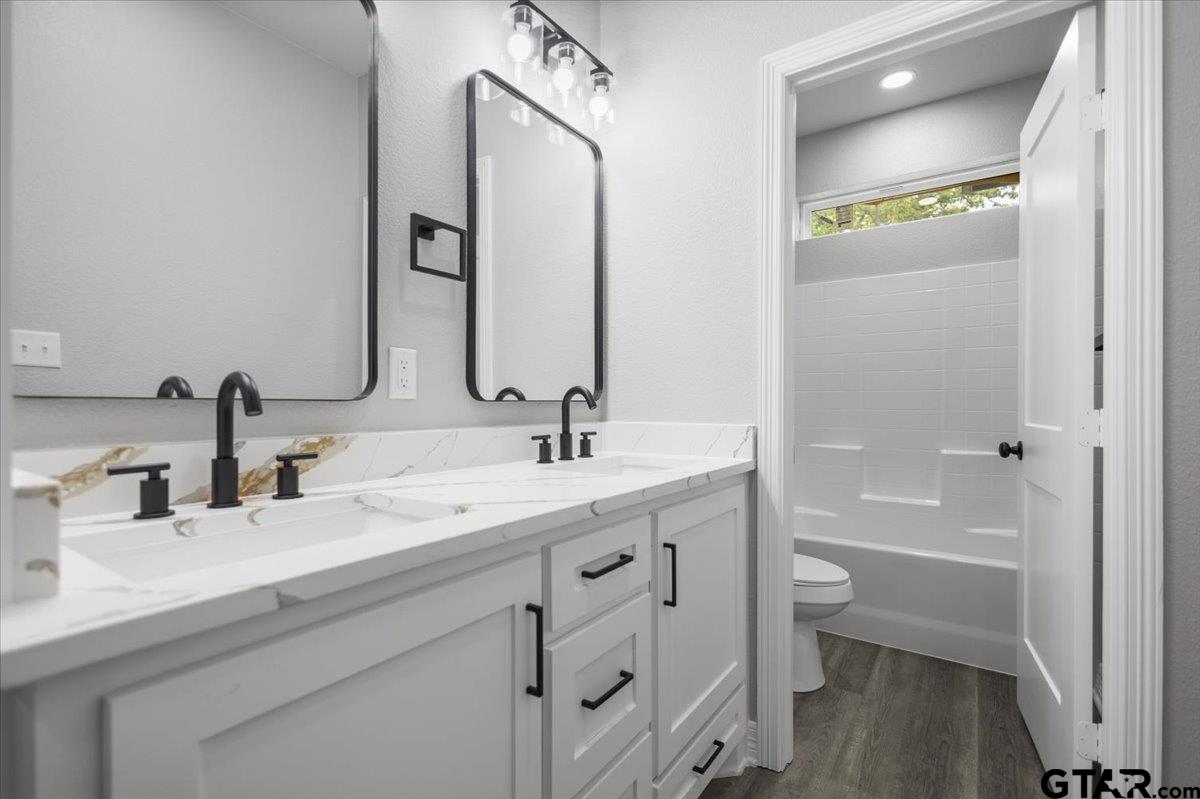 19462 Cedarpark Place Lindale, TX 75771 - Photo 43 of 48 a bathroom with a double vanity sink a toilet and a mirror