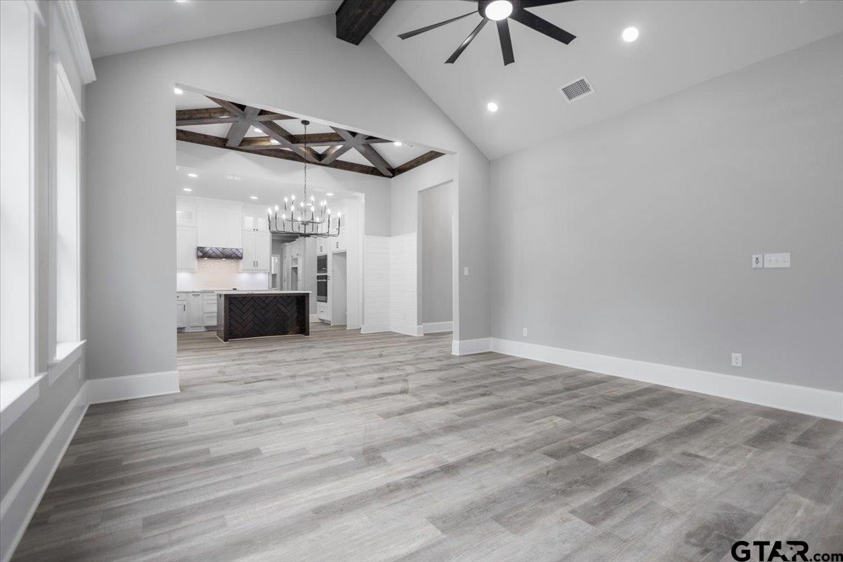19462 Cedarpark Place Lindale, TX 75771 - Photo 9 of 48 an empty room with wooden floor ceiling fan and windows