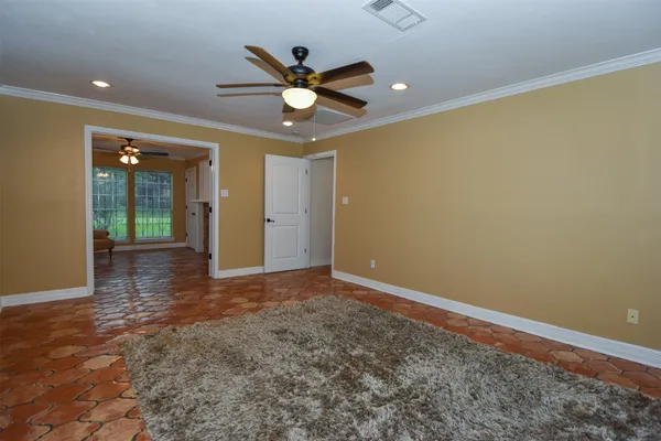 an empty room with closet and fan