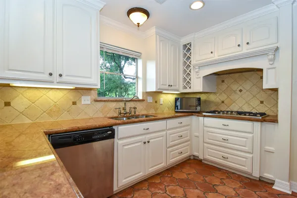 a kitchen with granite countertop white cabinets and white appliances