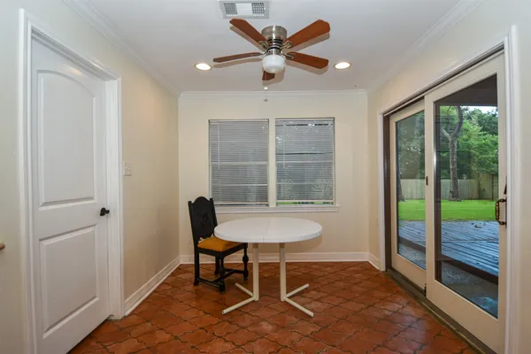 a view of a room with a table and chairs