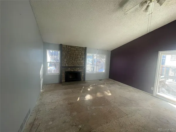 a view of empty room with a fireplace