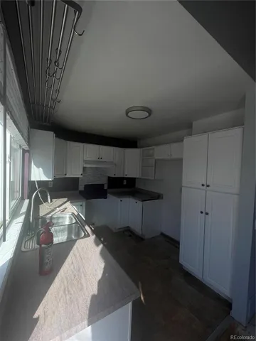 a kitchen with a sink dishwasher a stove and a refrigerator with wooden cabinets