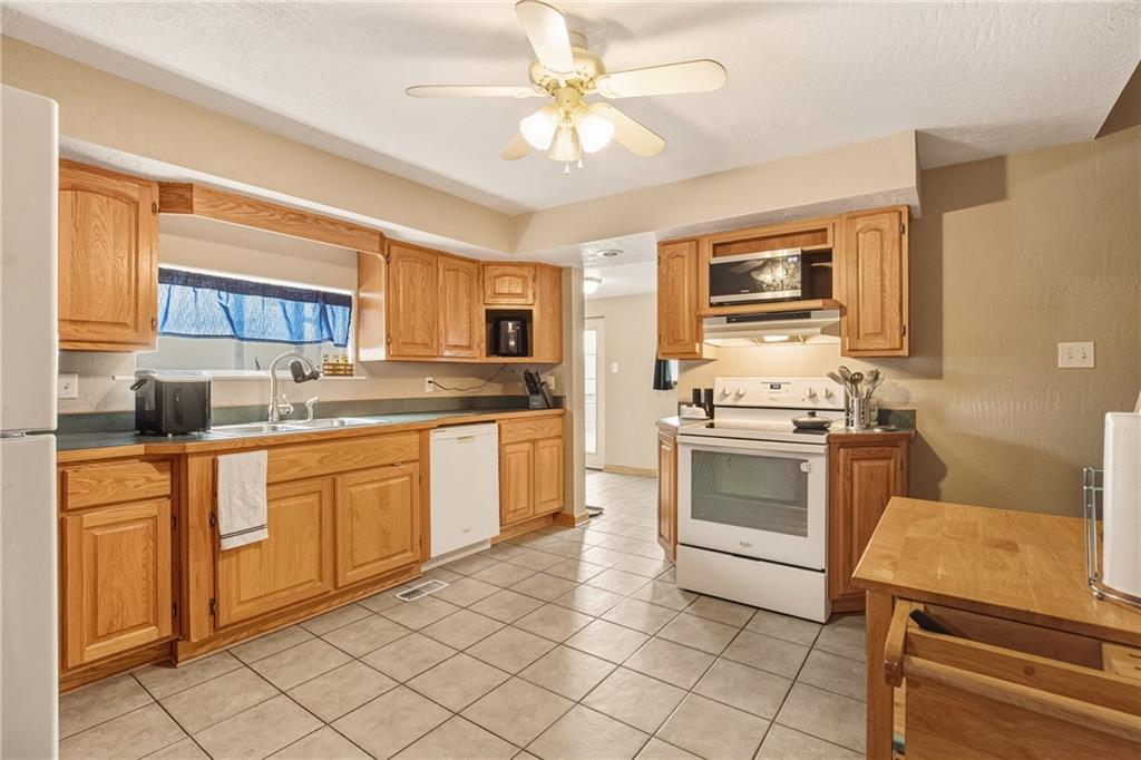 36 3rd Street Cairnbrook, PA 15924 - Photo 11 of 50 a kitchen with a stove a sink and a refrigerator