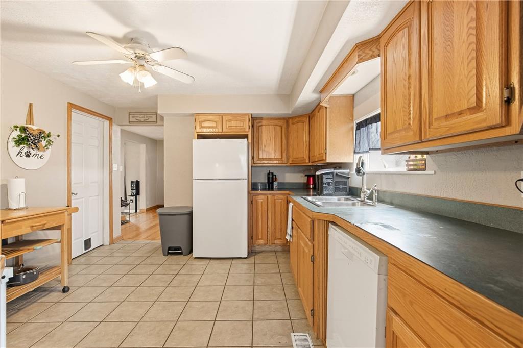 36 3rd Street Cairnbrook, PA 15924 - Photo 13 of 50 a kitchen with a refrigerator a sink and cabinets