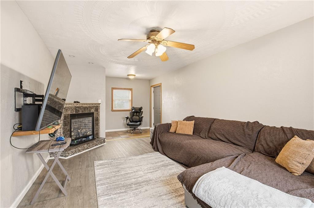 36 3rd Street Cairnbrook, PA 15924 - Photo 19 of 50 a living room with furniture a fireplace and a flat screen tv