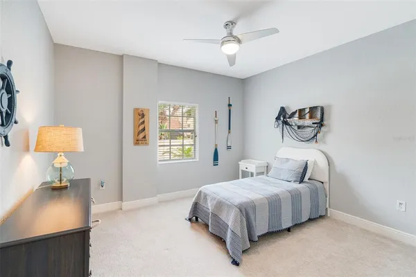 a bedroom with a bed and a lamp