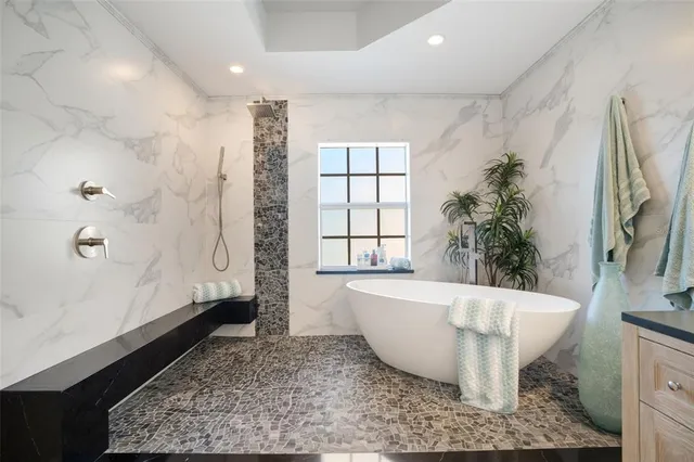 a bathroom with a bathtub and shower