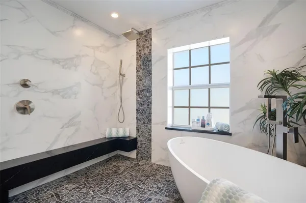 a bathroom with a bathtub and a shower